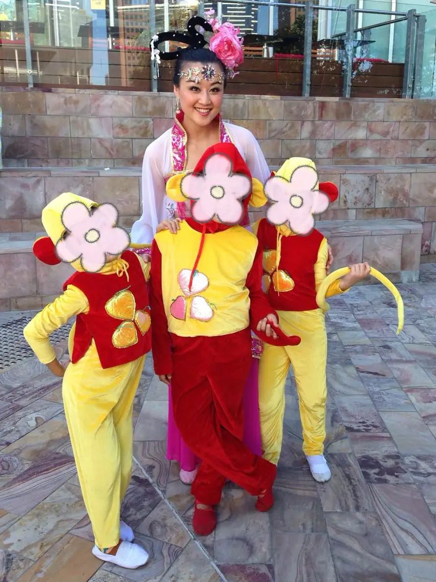 Raina with three children dressed in lion costumes