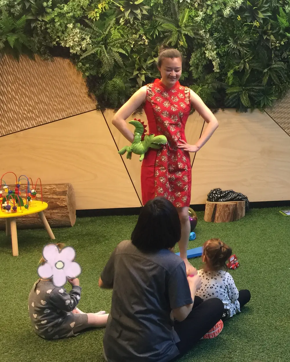 Raina leading a session with young children on a play mat