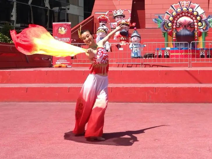 Raina dancing with a silk ribbon on an outdoor stage
