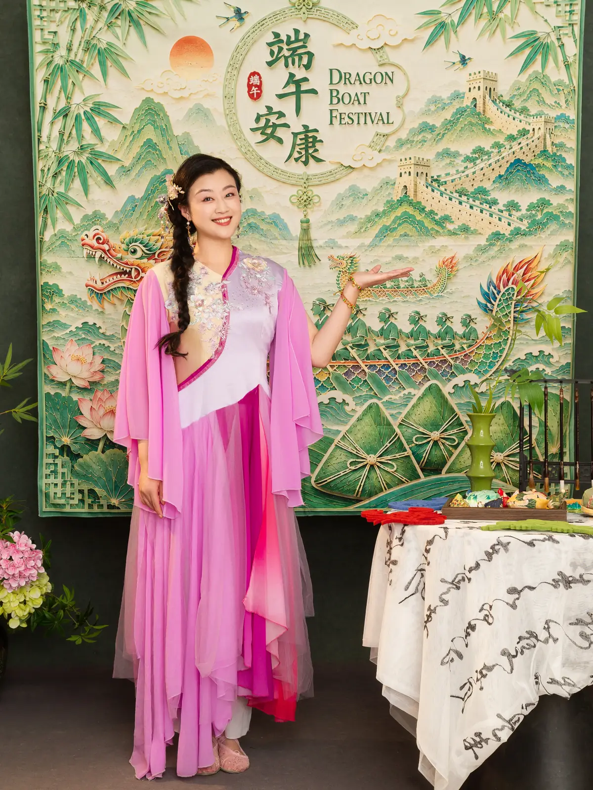 Raina beside a table of Dragon Boat Festival props