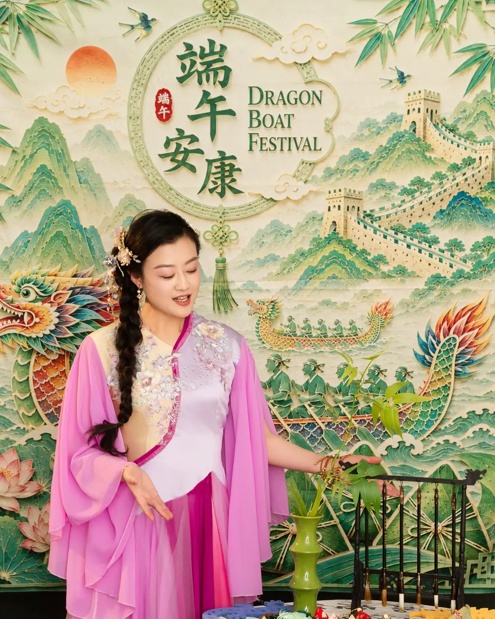 Raina smiling in front of the Dragon Boat Festival backdrop