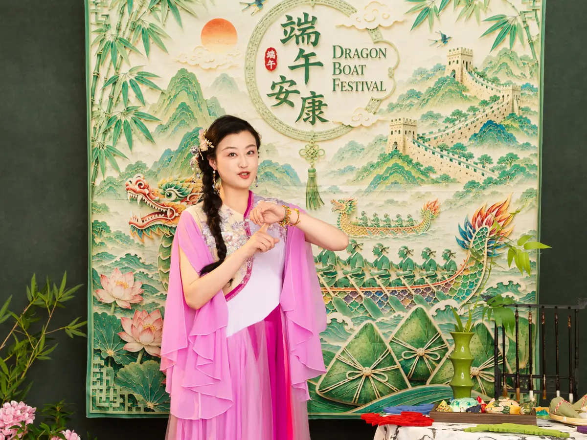 Raina in front of a Dragon Boat Festival backdrop