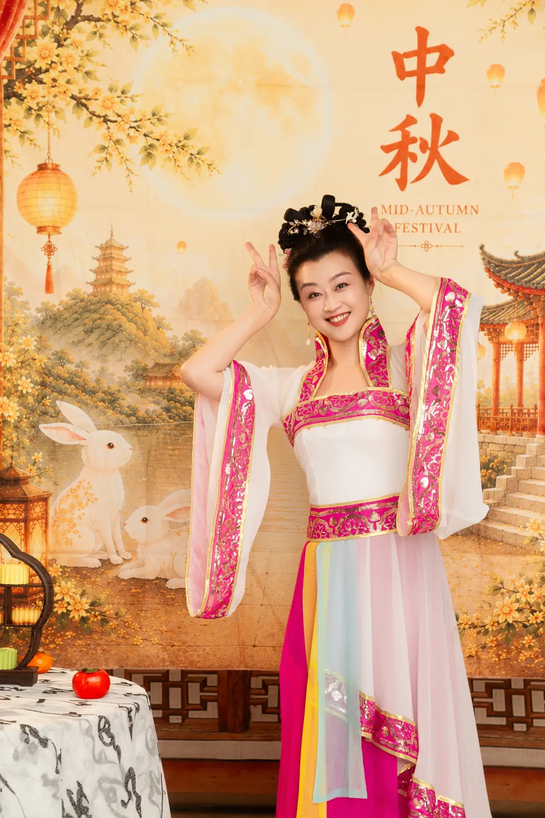 Raina in a Mid-Autumn costume in front of a moon and rabbit backdrop