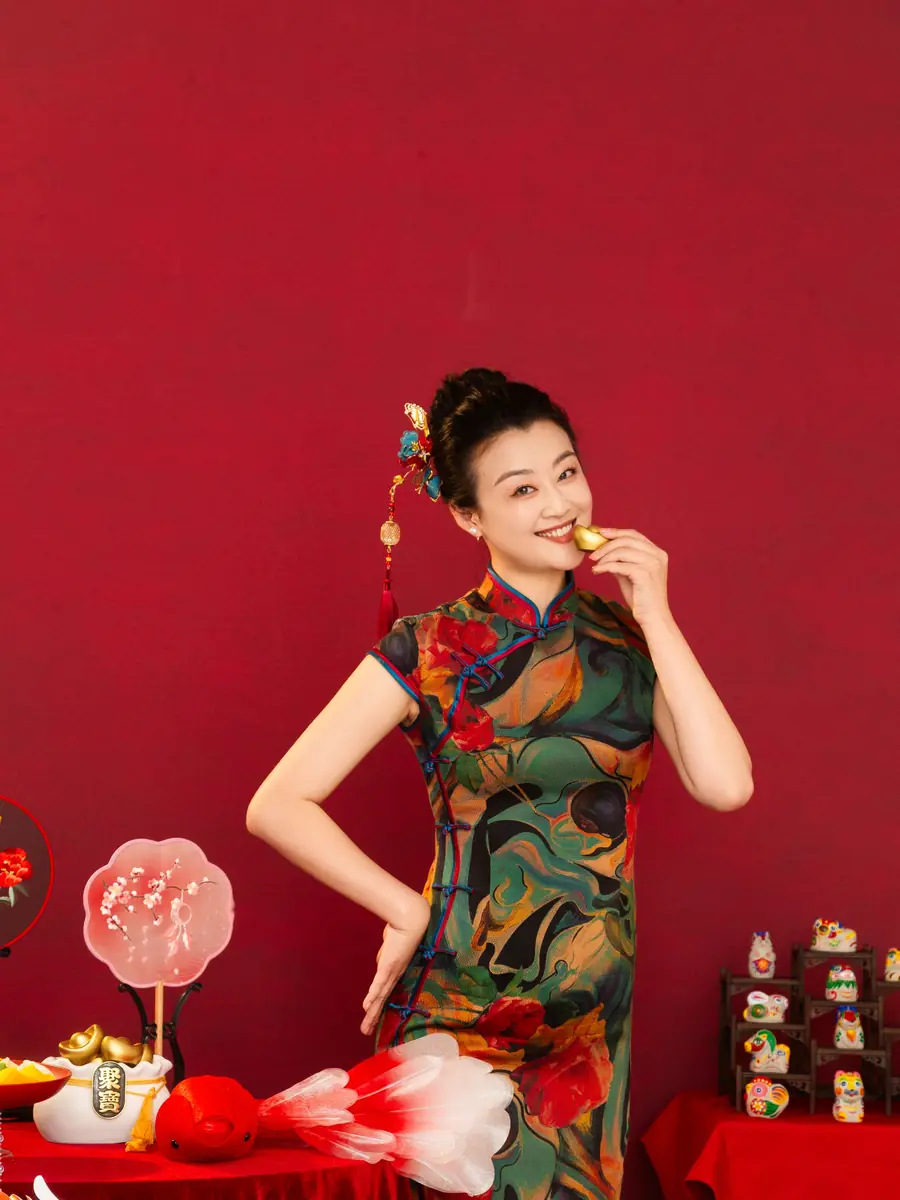 Raina smiling in a floral qipao