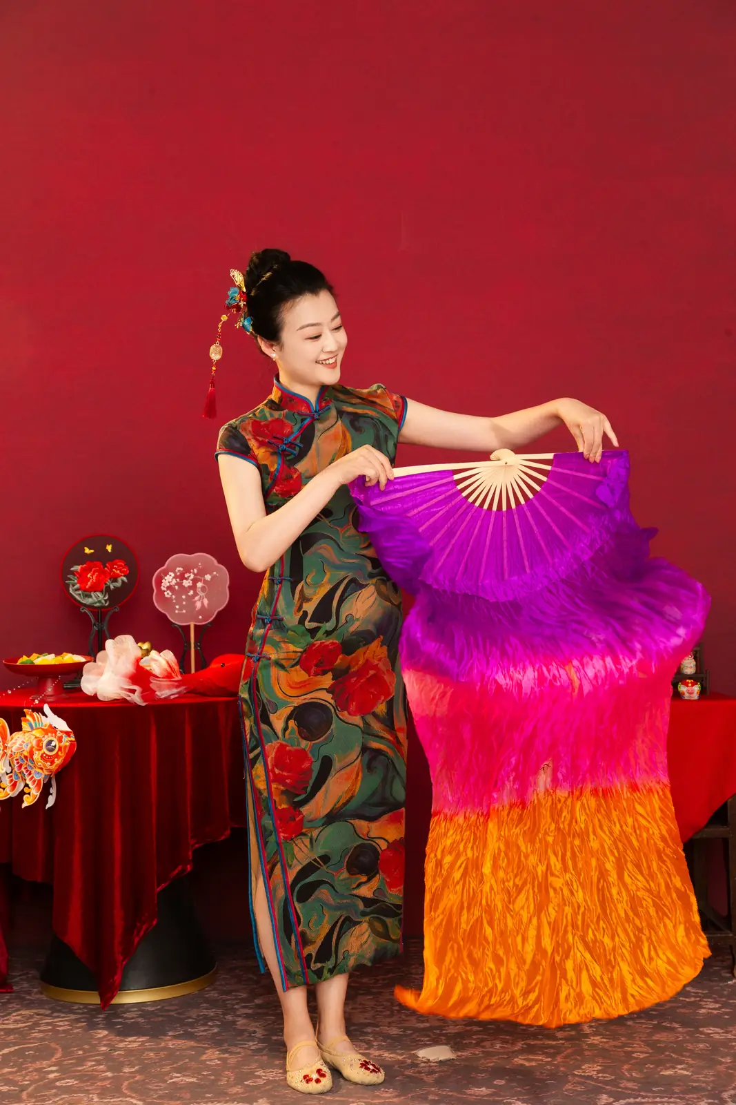 Raina dancing with a large purple silk fan